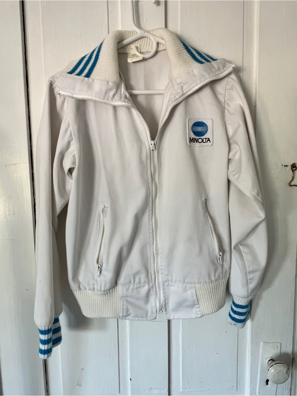 White Bomber Jacket with Blue Minolta patch and blue Accents
